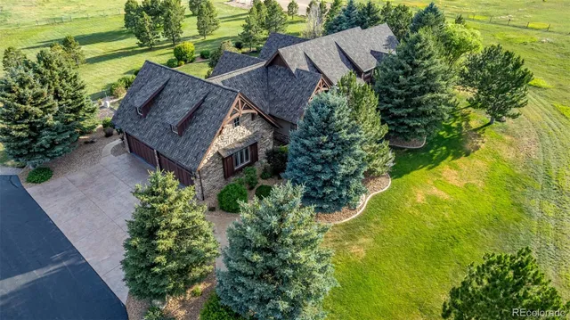 an aerial view of a house with pool outdoor seating and yard