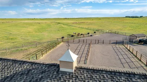 a view of a house with a yard and a large tree