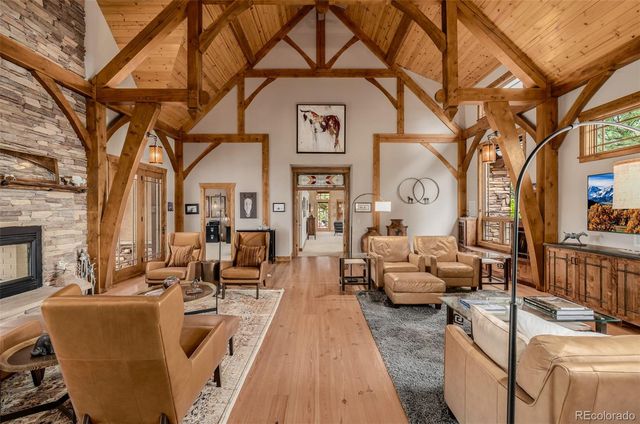 a view of a patio with couches fire pit and a barbeque grill with couches and wooden fence