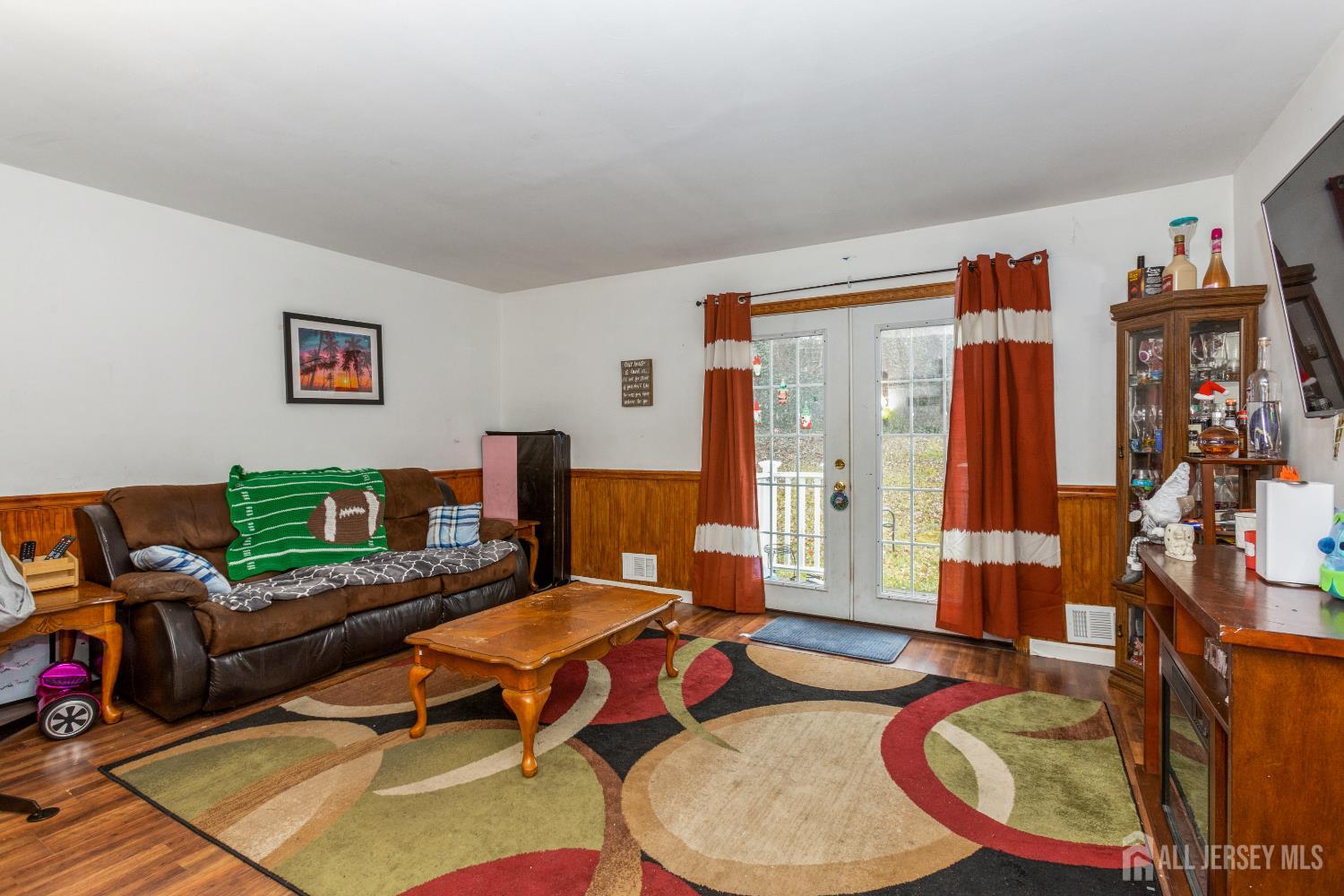 332 Ernston Road Parlin, NJ 08859 - Photo 3 of 14 a living room with furniture a flat screen tv and a dining table