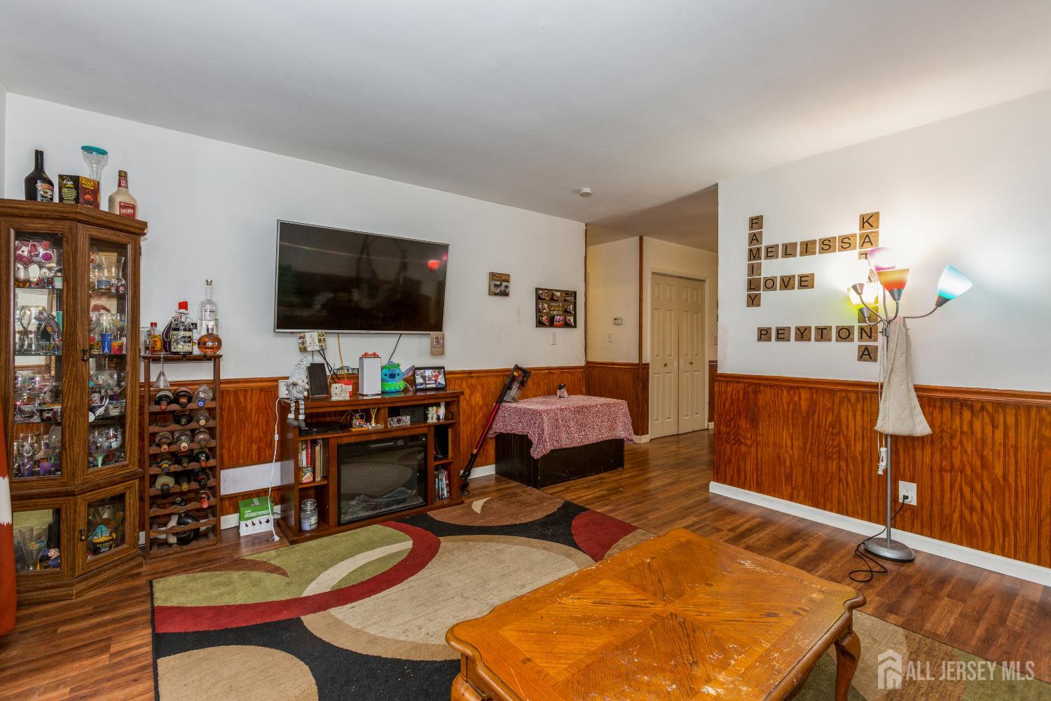 332 Ernston Road Parlin, NJ 08859 - Photo 4 of 14 a living room with furniture and a flat screen tv