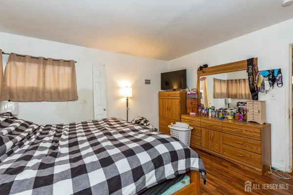 a bedroom with a bed and dresser