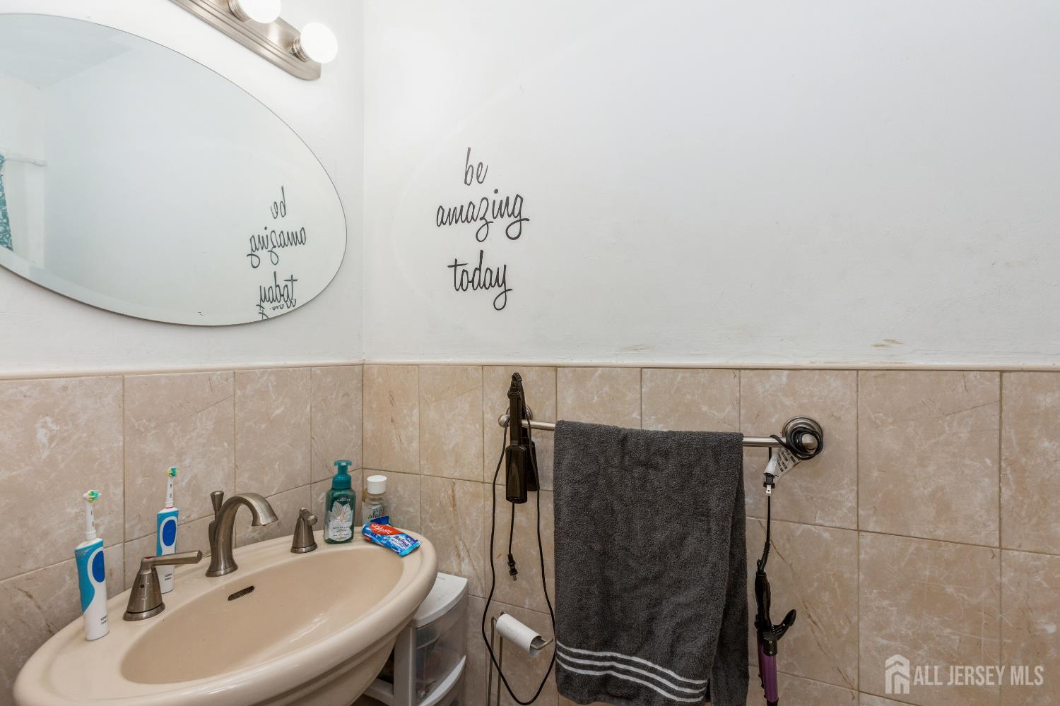 332 Ernston Road Parlin, NJ 08859 - Photo 10 of 14 a bathroom with a sink and mirror