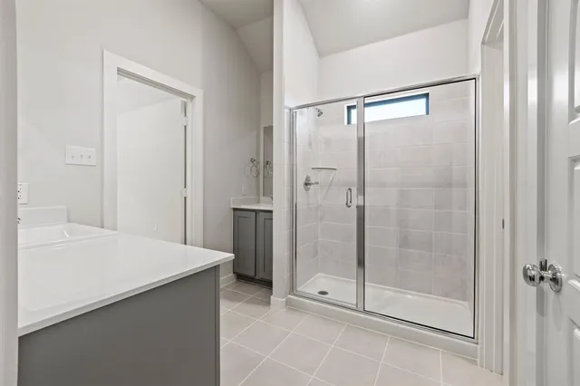 a bathroom with a shower and a sink