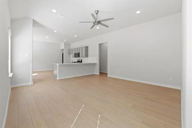 a view of a kitchen with a sink and cabinets