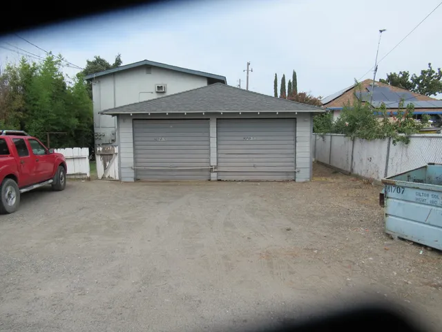a view of a house with a yard and garage