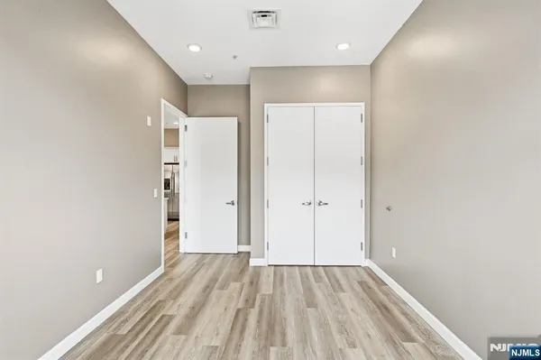 a view of hallway with wooden floor