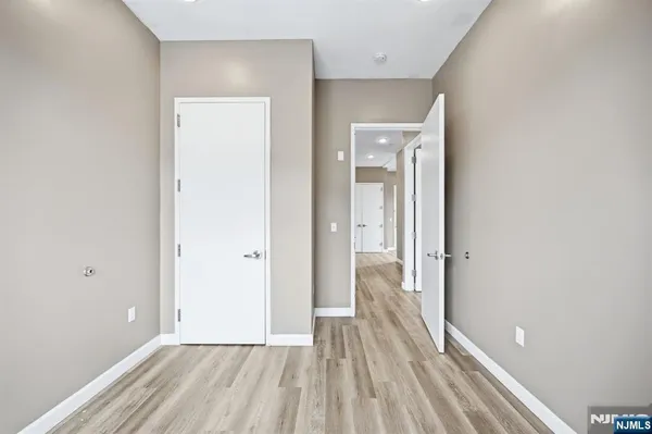 a view of a room with wooden floor