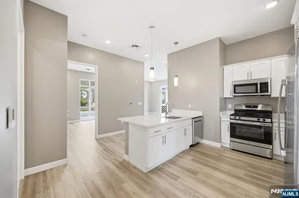 a large kitchen with a stove top oven