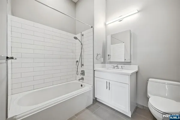 a bathroom with a sink a toilet and bathtub