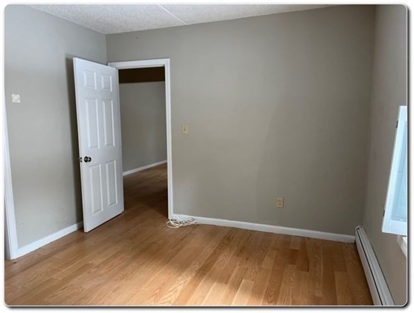 15 Lawrence Road, Unit 20 Rowley, MA 01969 - Photo 15 of 22 an empty room with wooden floor and entrance
