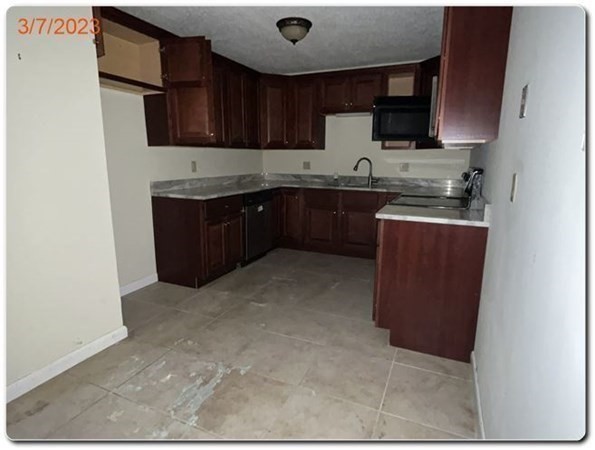 15 Lawrence Road, Unit 20 Rowley, MA 01969 - Photo 10 of 22 a kitchen with stainless steel appliances granite countertop a refrigerator and a stove top oven