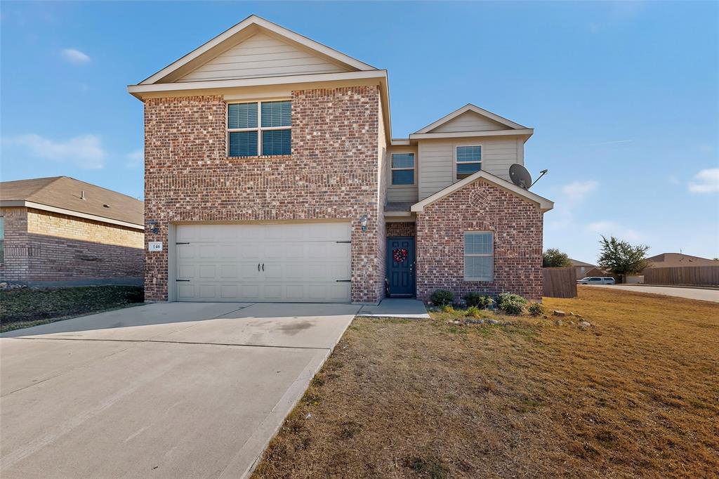 148 Point Rider Road Newark, TX 76071 - Photo 2 of 40 Traditional home with concrete driveway, brick siding, and a garage