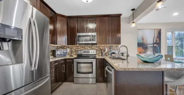 a kitchen with a refrigerator and a table
