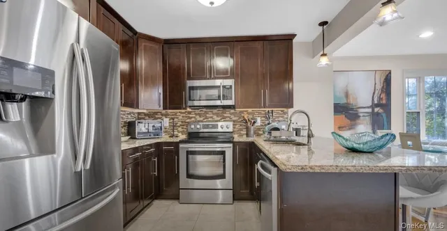 a kitchen with a refrigerator and a table