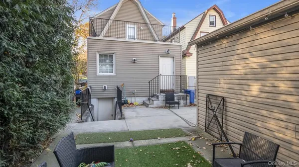 a living room with furniture a mirror and a view of a bathroom