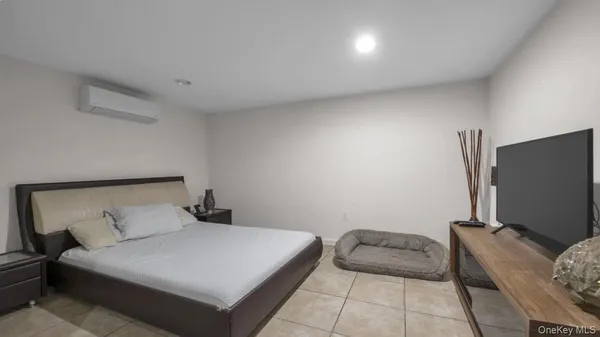 a bedroom with a bed dresser and a window
