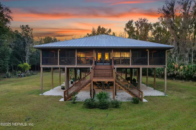 a view of a chair and table in backyard of the house