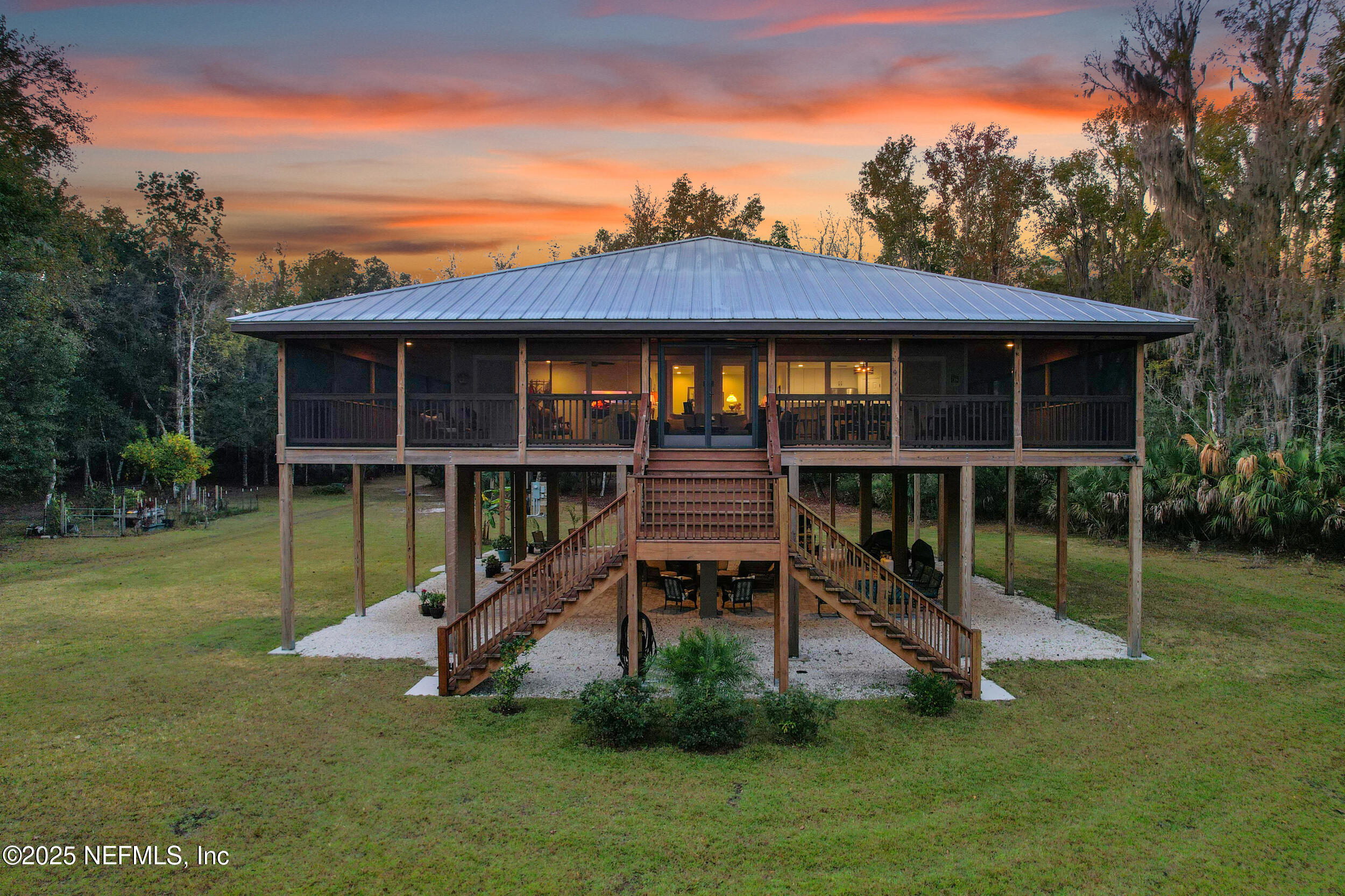 a view of a chair and table in backyard of the house