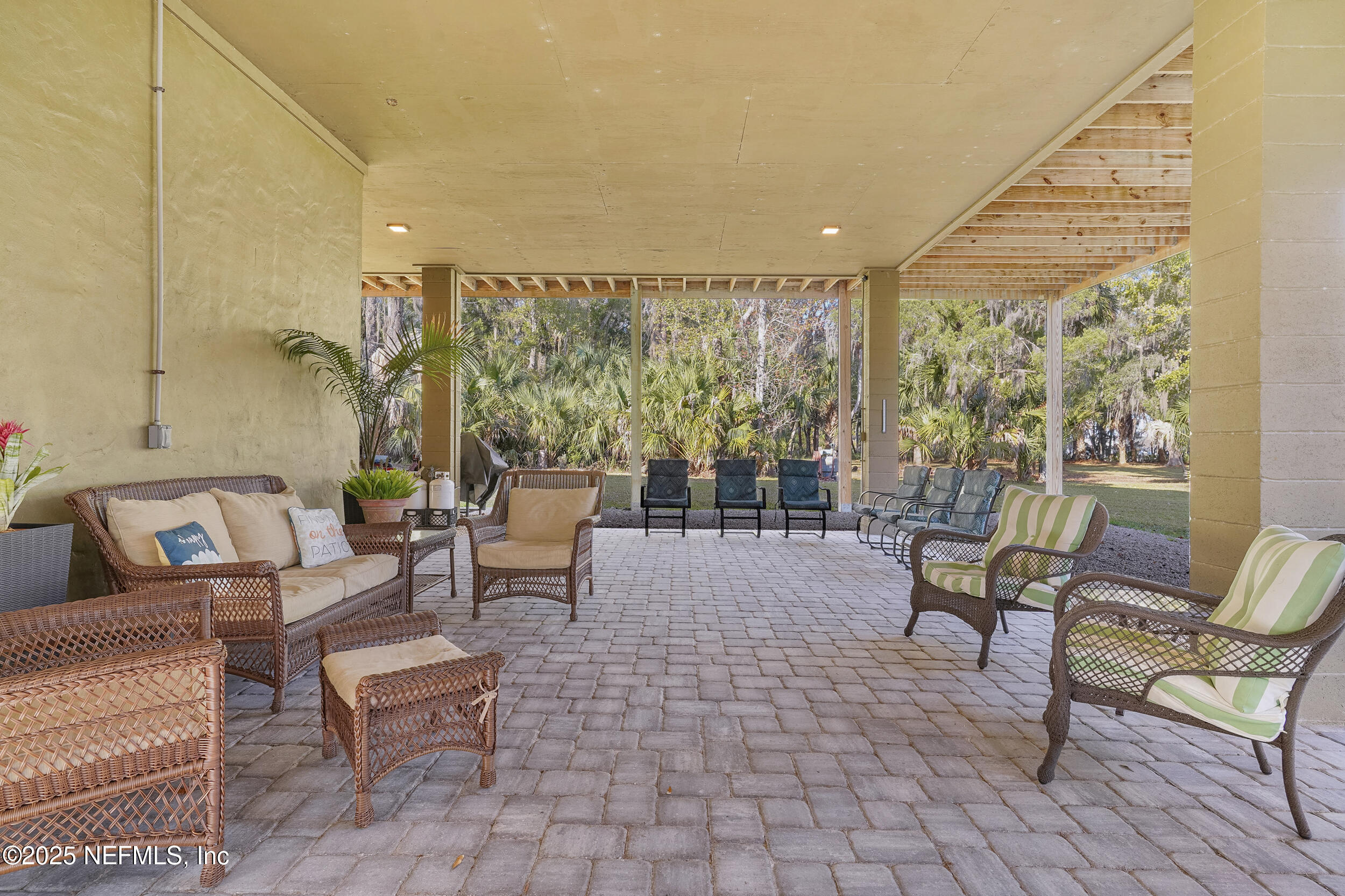 122 Drayton Island Road Georgetown, FL 32139 - Photo 13 of 59 a outdoor living space with furniture and a floor to ceiling window
