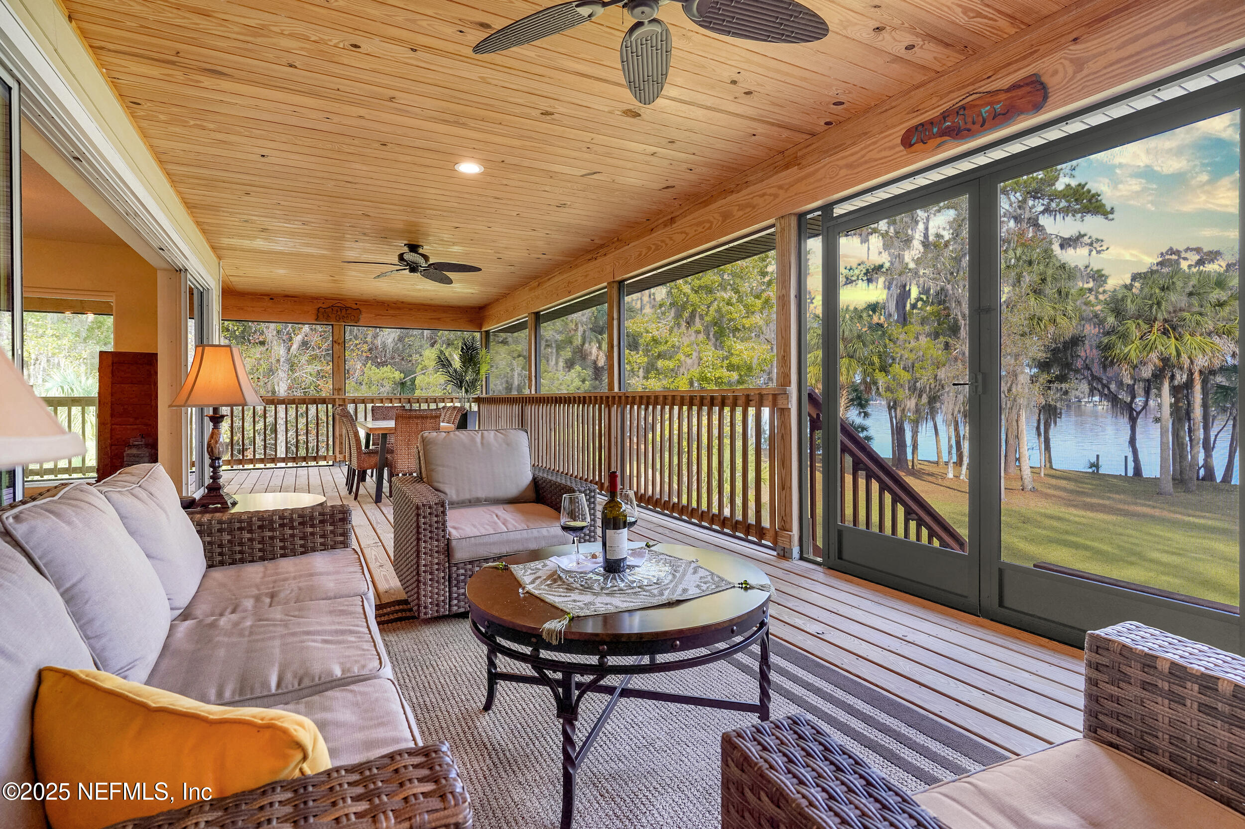122 Drayton Island Road Georgetown, FL 32139 - Photo 16 of 59 a living room with furniture and a floor to ceiling window