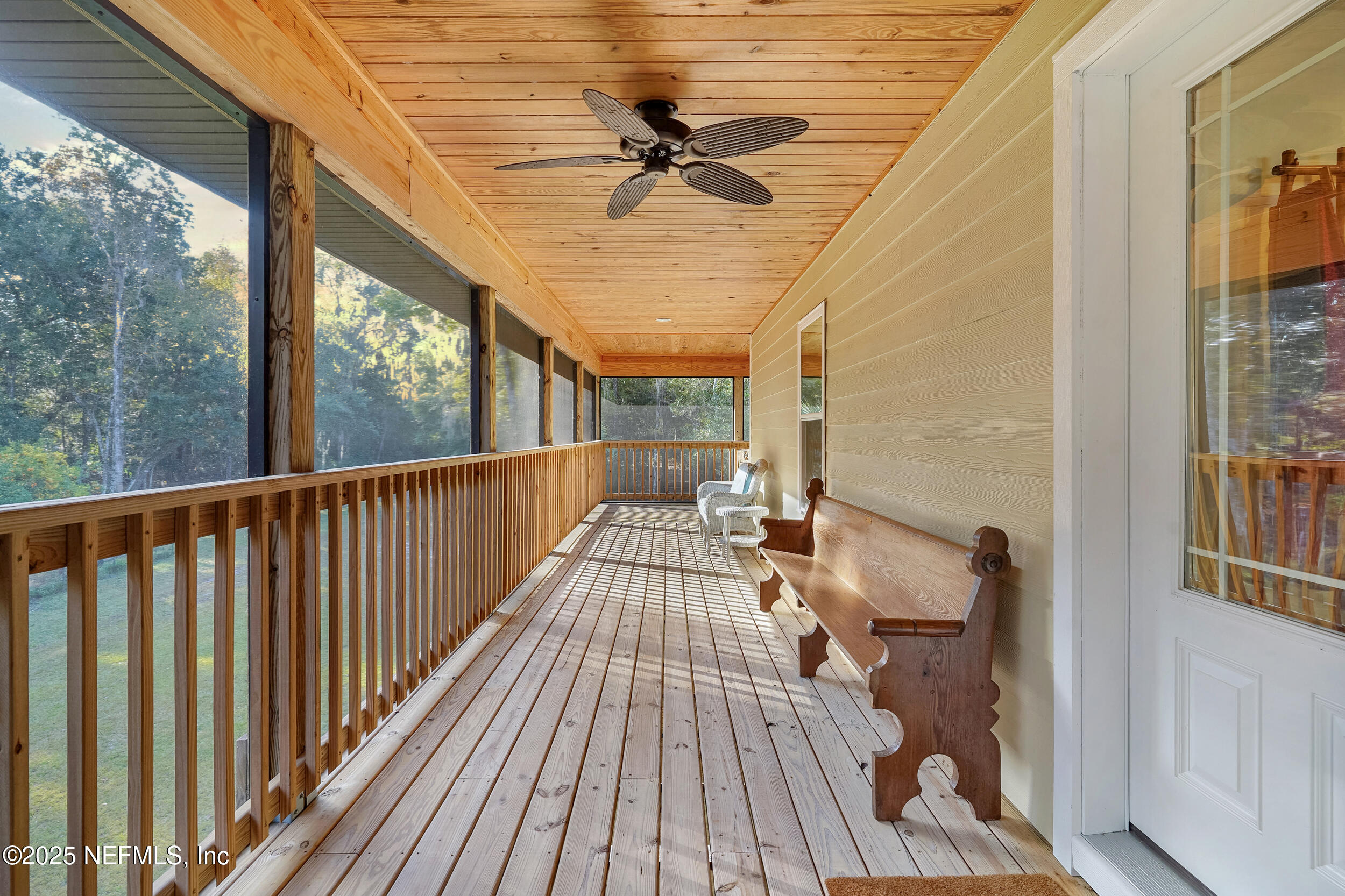 122 Drayton Island Road Georgetown, FL 32139 - Photo 18 of 59 a view of a balcony with furniture and a ceiling fan