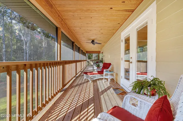 a living room with furniture and a dining table with kitchen view