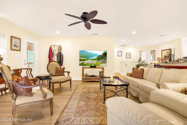 a kitchen with stainless steel appliances granite countertop a refrigerator a stove and a wooden floors