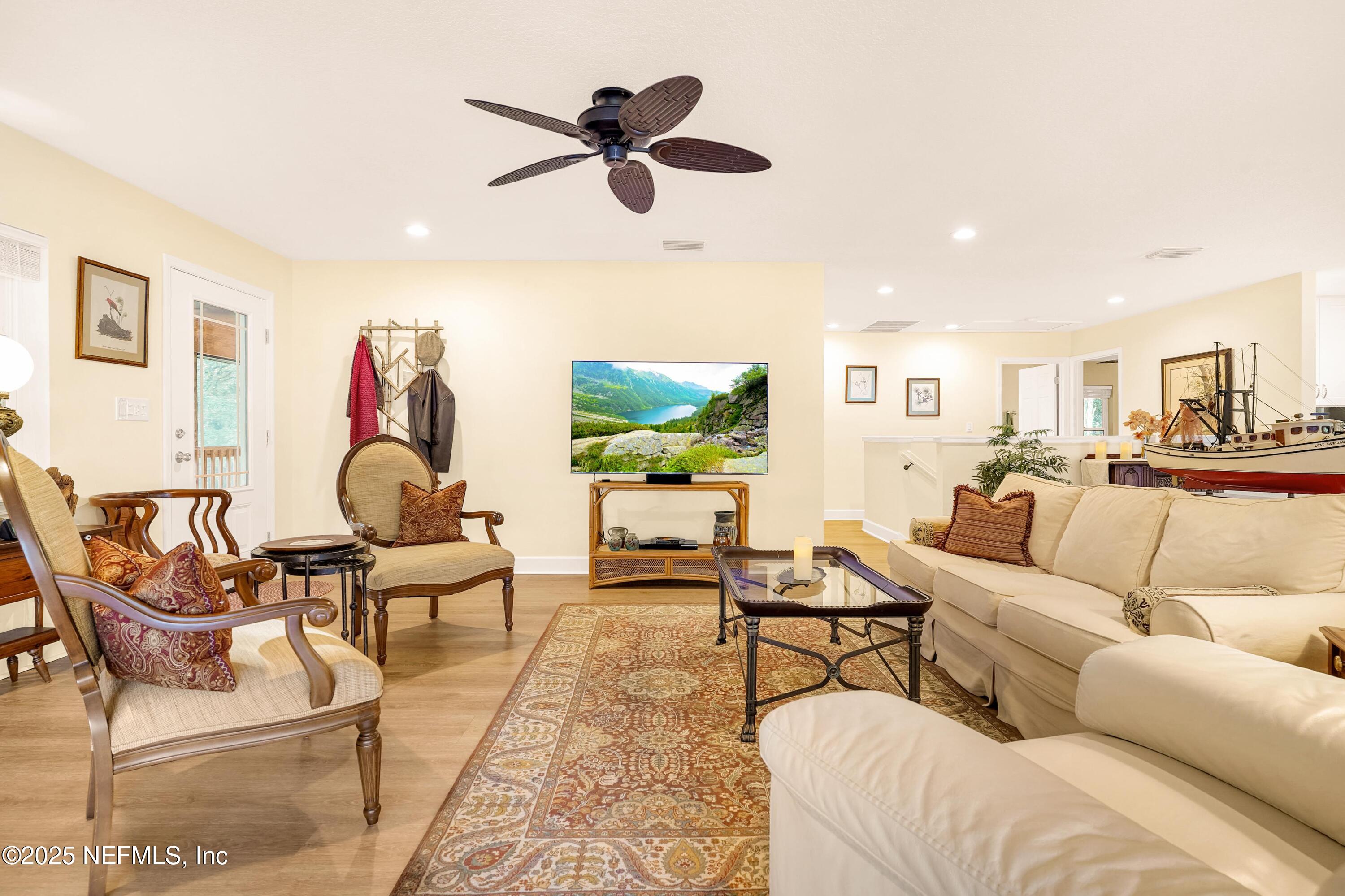 122 Drayton Island Road Georgetown, FL 32139 - Photo 22 of 59 a living room with furniture and a flat screen tv with wooden floor