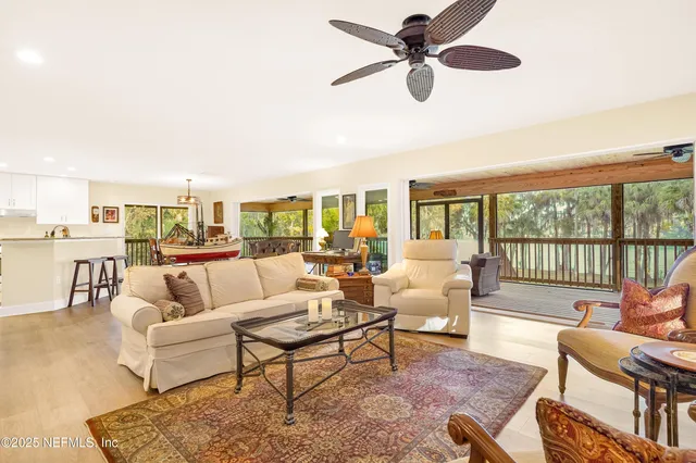a bedroom with a bed chandelier and a window