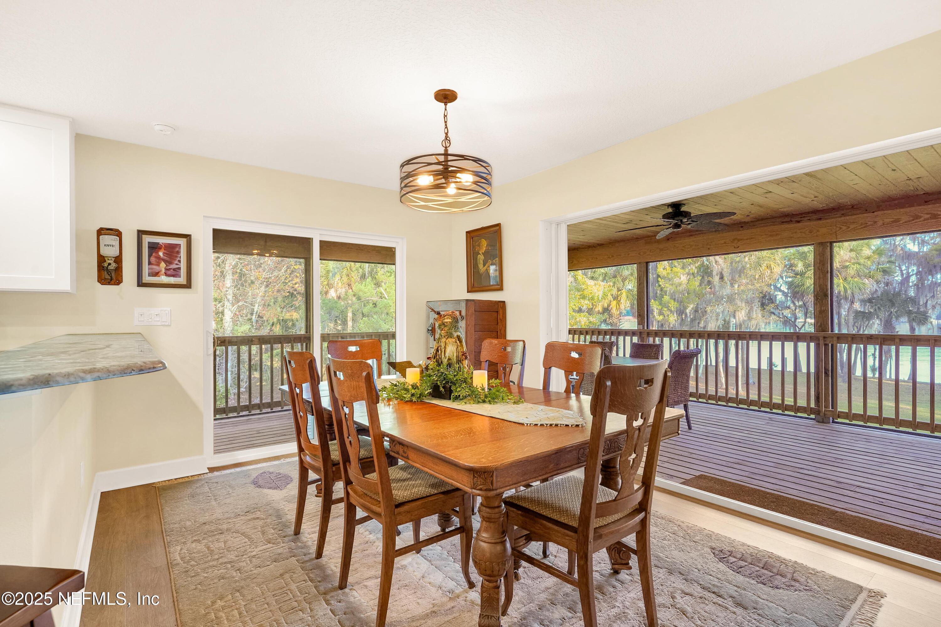 122 Drayton Island Road Georgetown, FL 32139 - Photo 26 of 58 a view of a dining room with furniture window and wooden floor