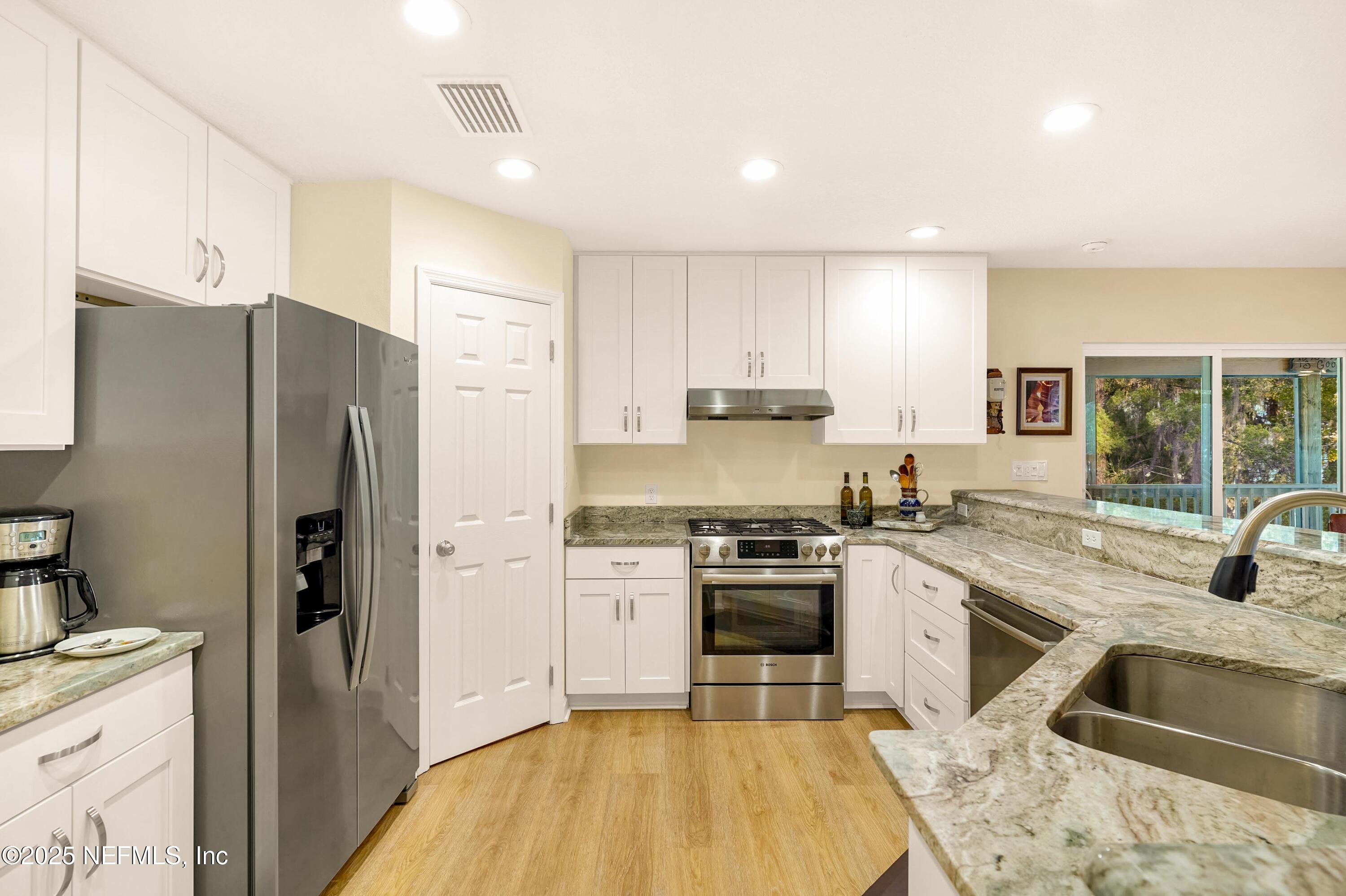 122 Drayton Island Road Georgetown, FL 32139 - Photo 28 of 59 a kitchen with a sink stove and refrigerator