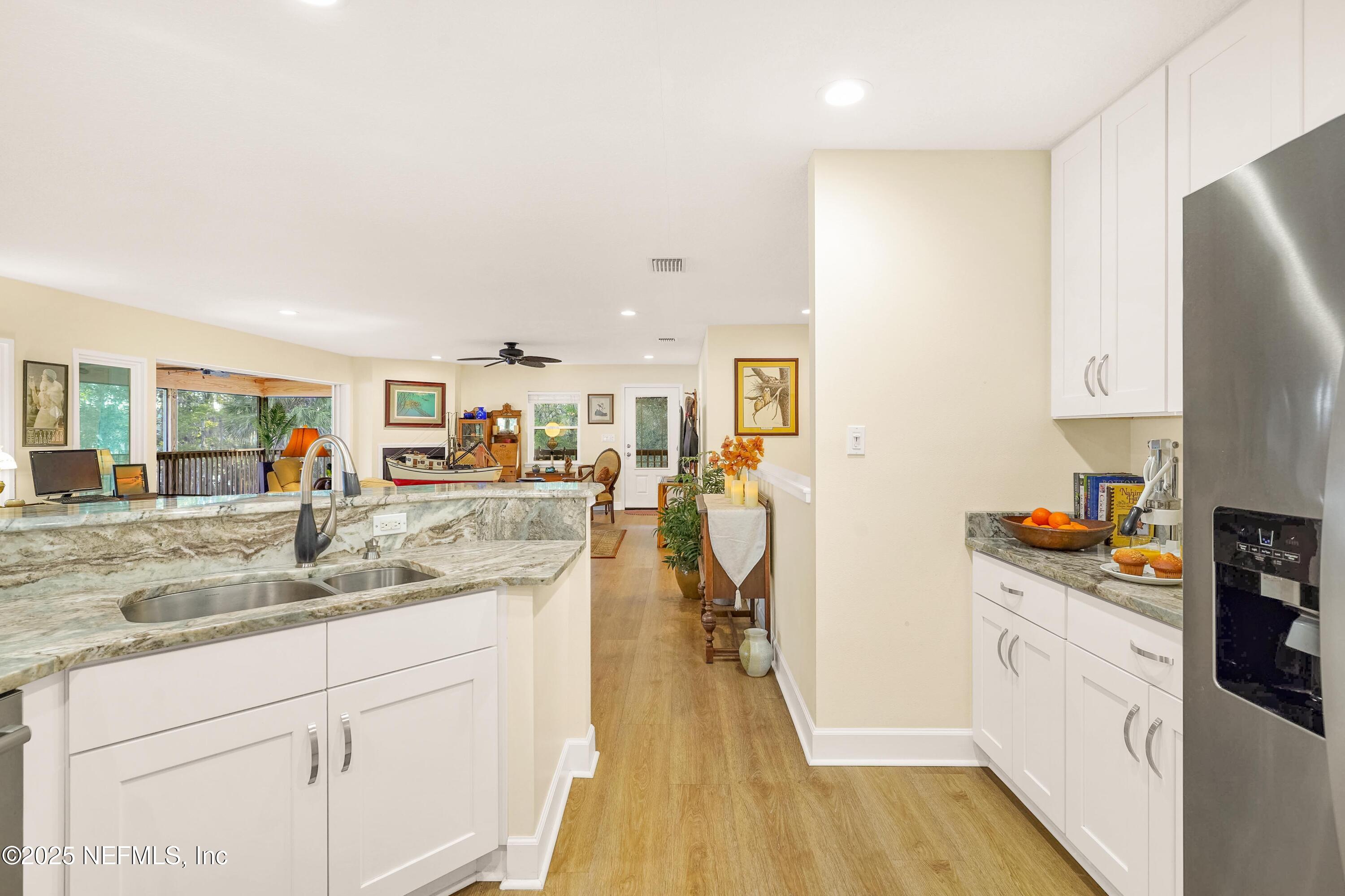 122 Drayton Island Road Georgetown, FL 32139 - Photo 30 of 59 a kitchen with stainless steel appliances granite countertop a refrigerator a stove and a wooden floors
