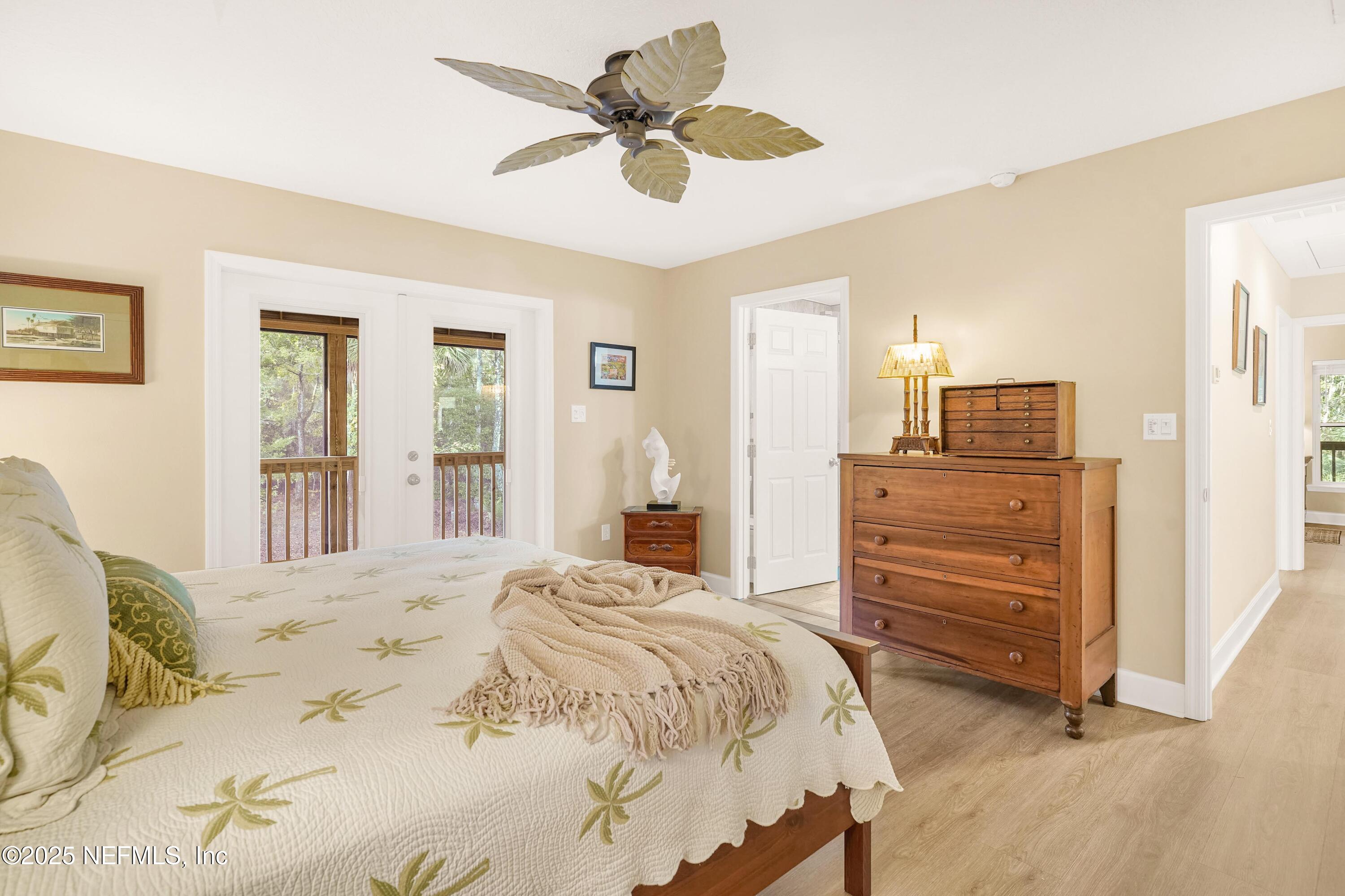 122 Drayton Island Road Georgetown, FL 32139 - Photo 33 of 58 a bedroom with a bed and a chandelier