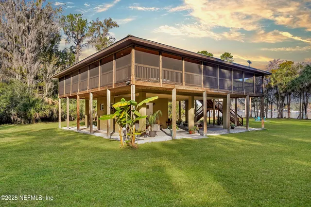 a view of a house that has a big yard