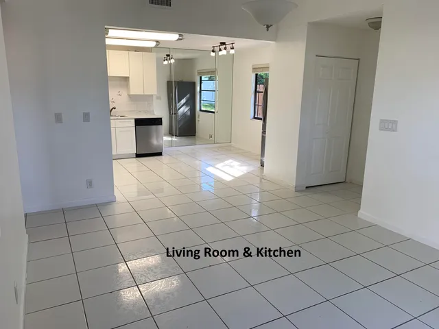 a view of a refrigerator and window in a kitchen
