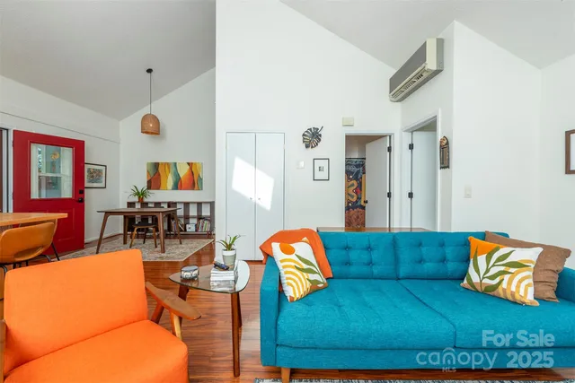 a living room with furniture and a floor to ceiling window