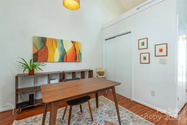 a view of a dining room with furniture and a potted plant