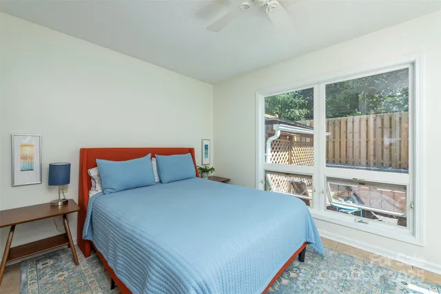 a large bed sitting in a bedroom next to a window