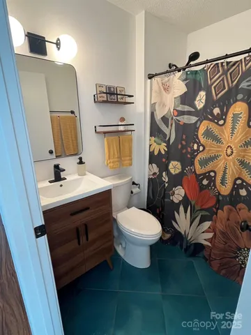 a bathroom with a sink mirror vanity and toilet