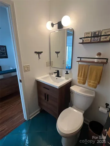 a bathroom with a toilet sink and mirror