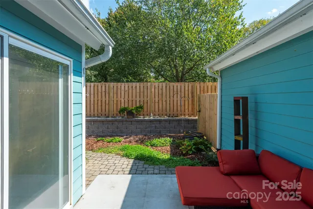 a view of house with backyard outdoor seating and green space