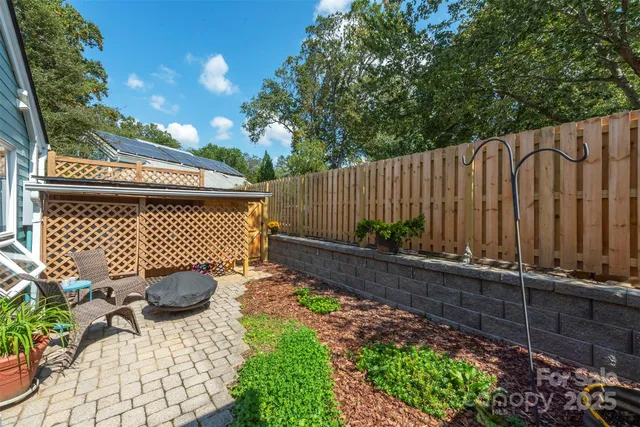 a view of a backyard with a chair and potted plant