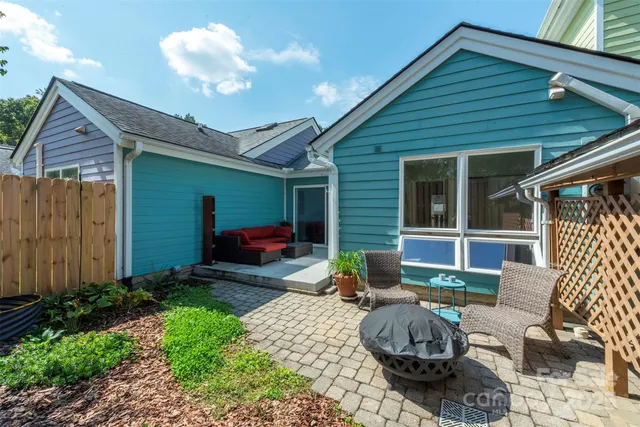 a view of a backyard with furniture and outdoor seating