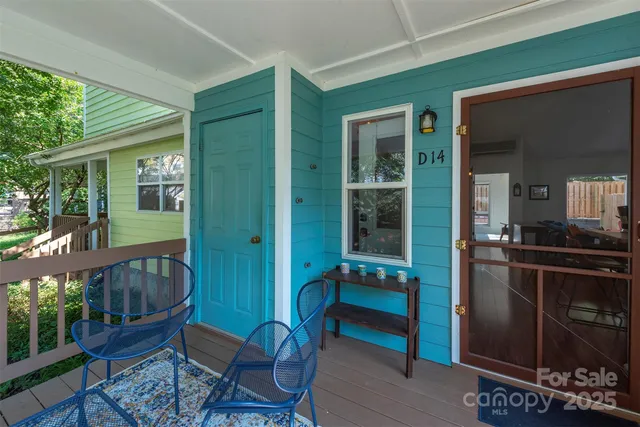 a view of a porch with chairs and front door