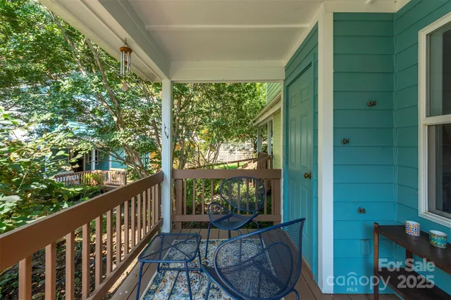 a view of a room with balcony and wooden floor