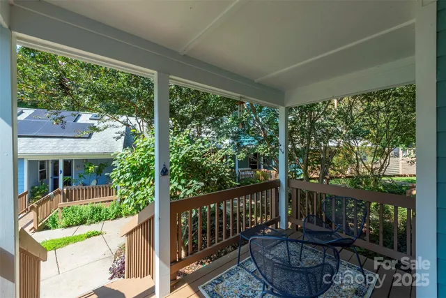 a view of a chair and tables in the balcony