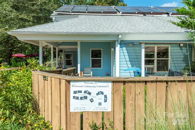 a view of a house with a porch and furniture