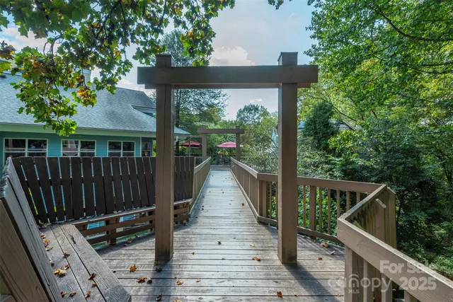 a view of house with wooden floor and outdoor seating