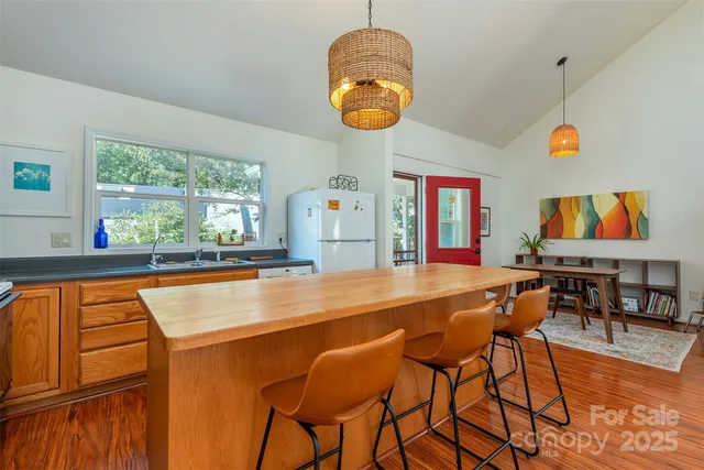 a dining room with furniture and a large window